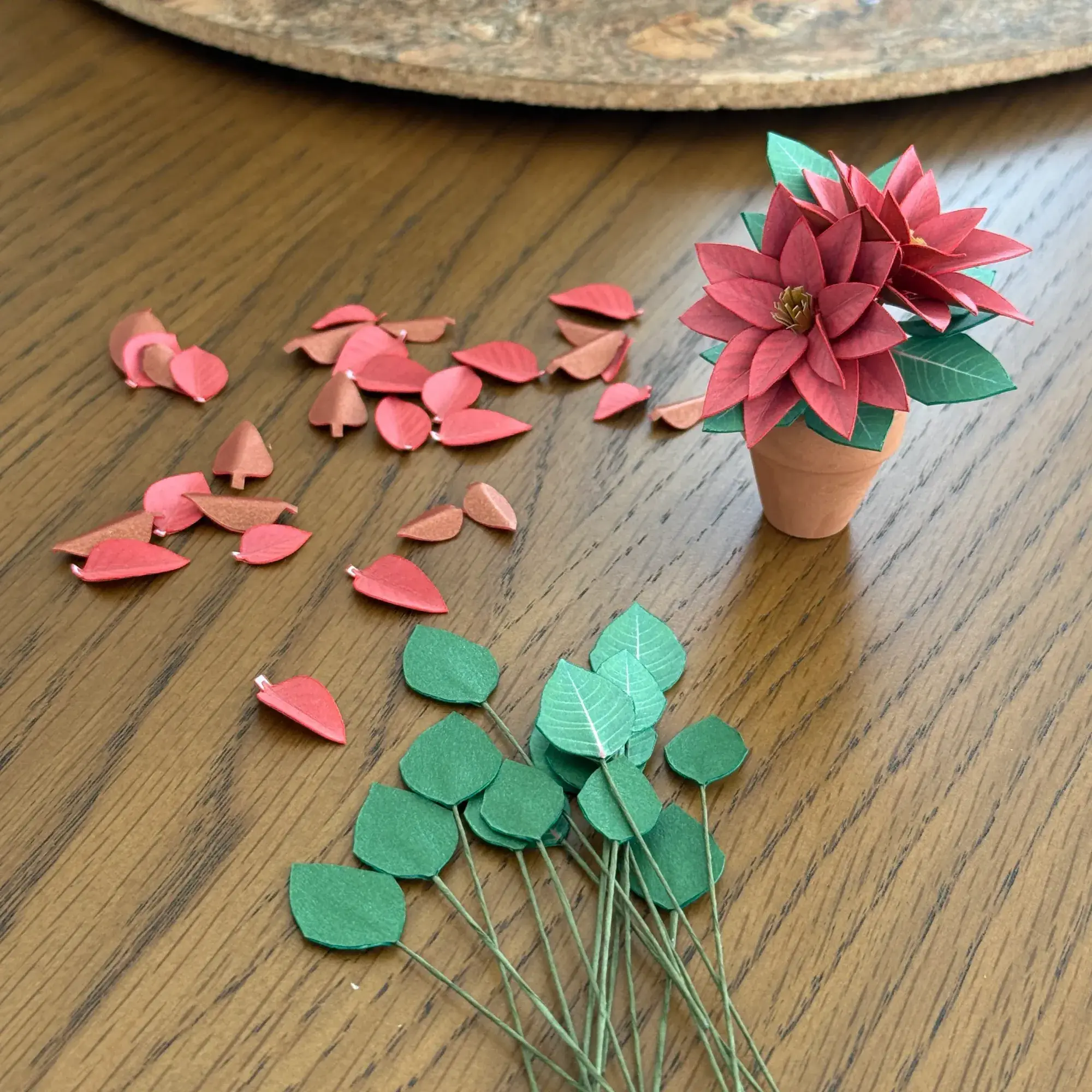 Cut paper Poinsettia leaves ready to assemble