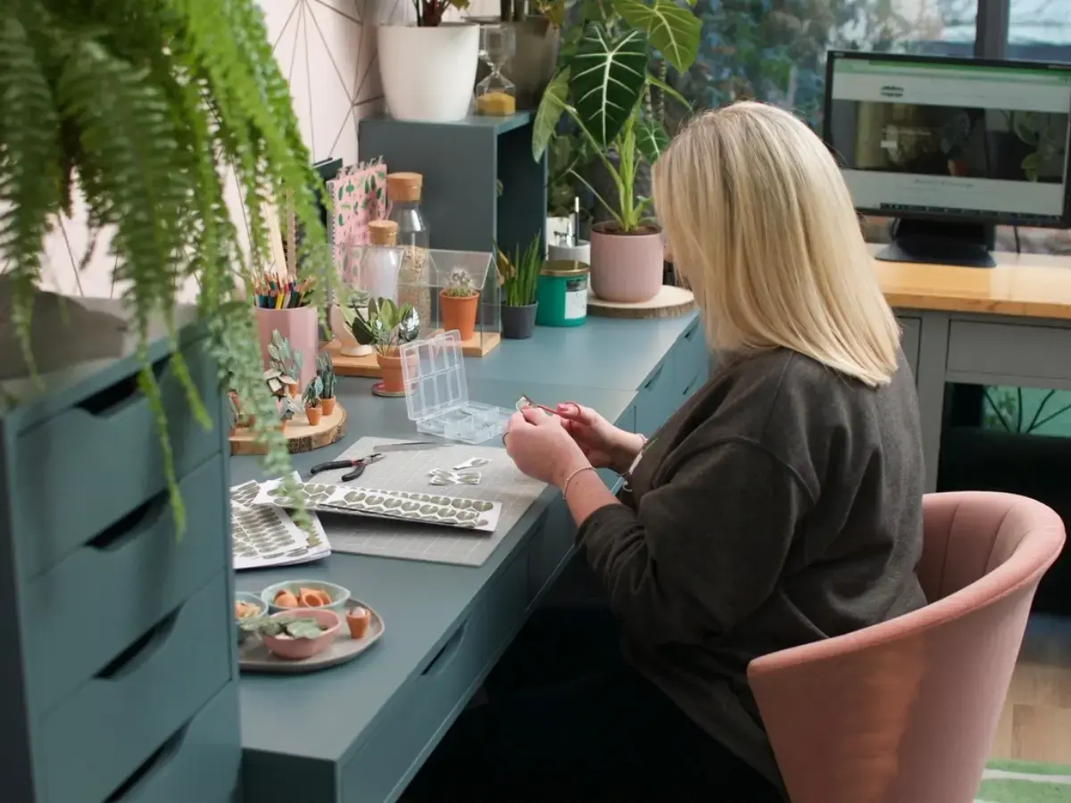 Nicole crafting paper plants in her studio