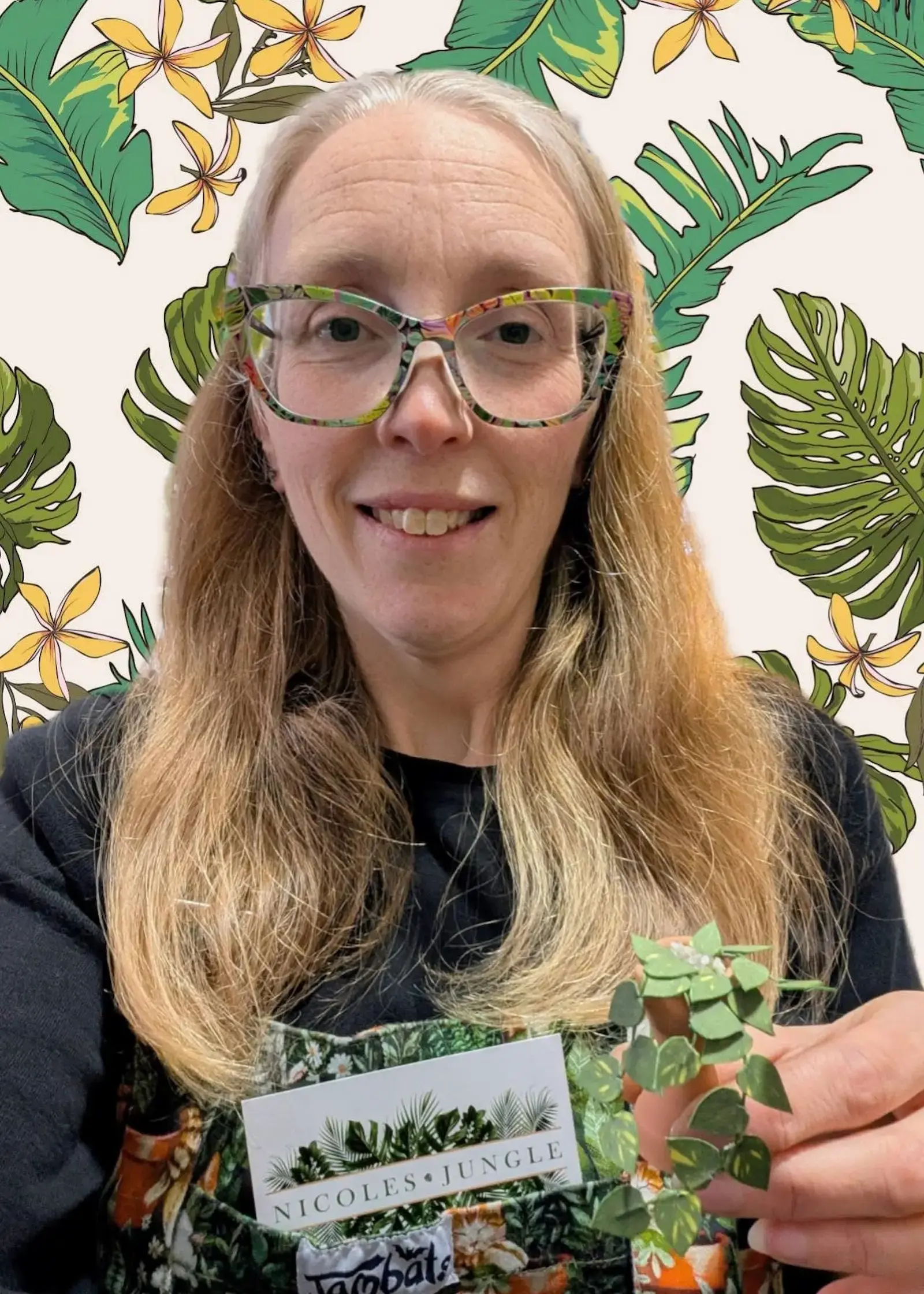 Customer holding a miniature paper pothos in a terracotta pot