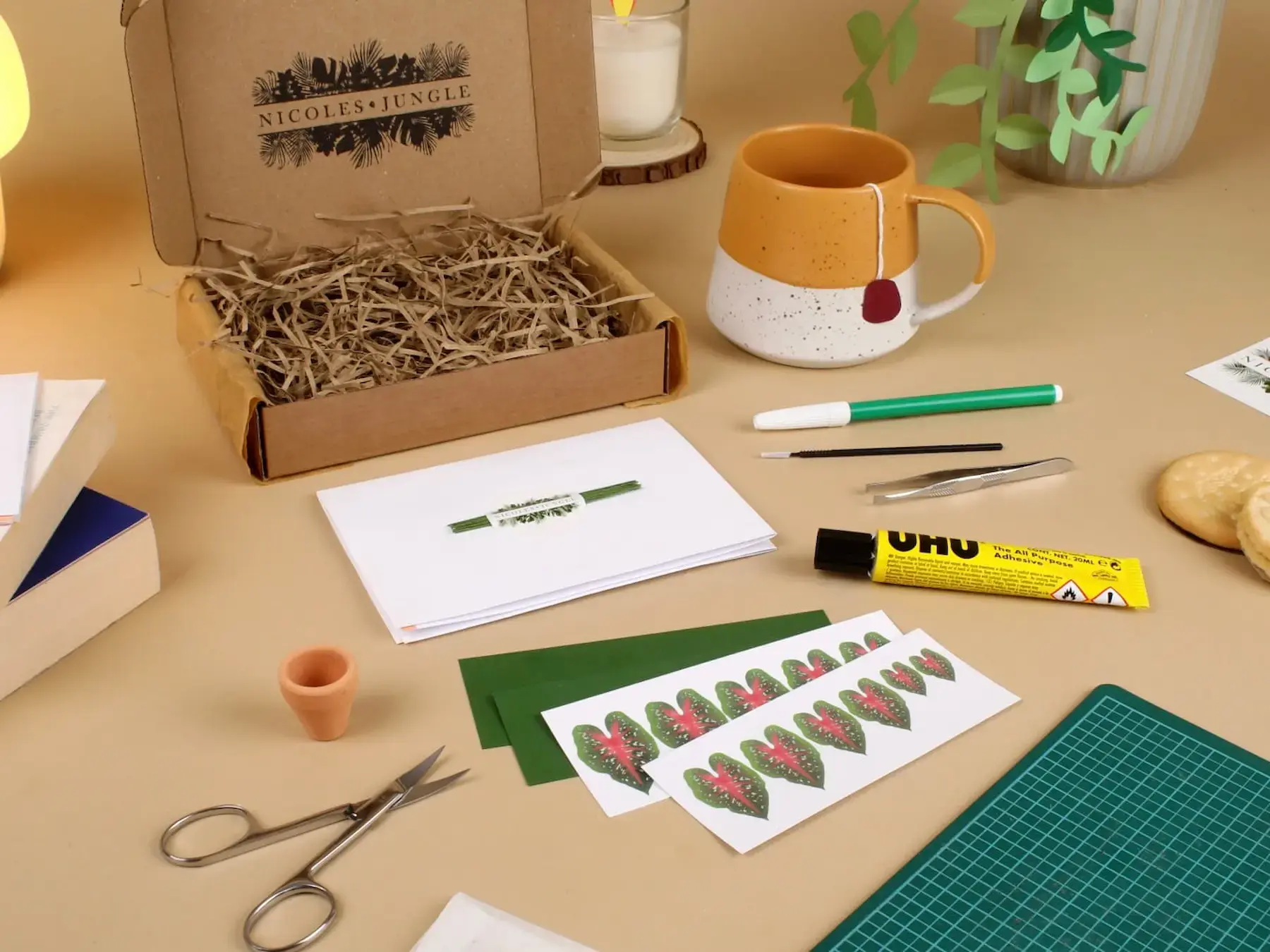 Nicole's Jungle craft kit laid out with tools and paper leaves