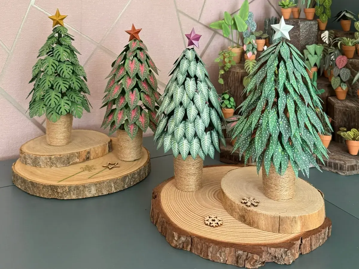 Four handmade paper Christmas trees in different styles